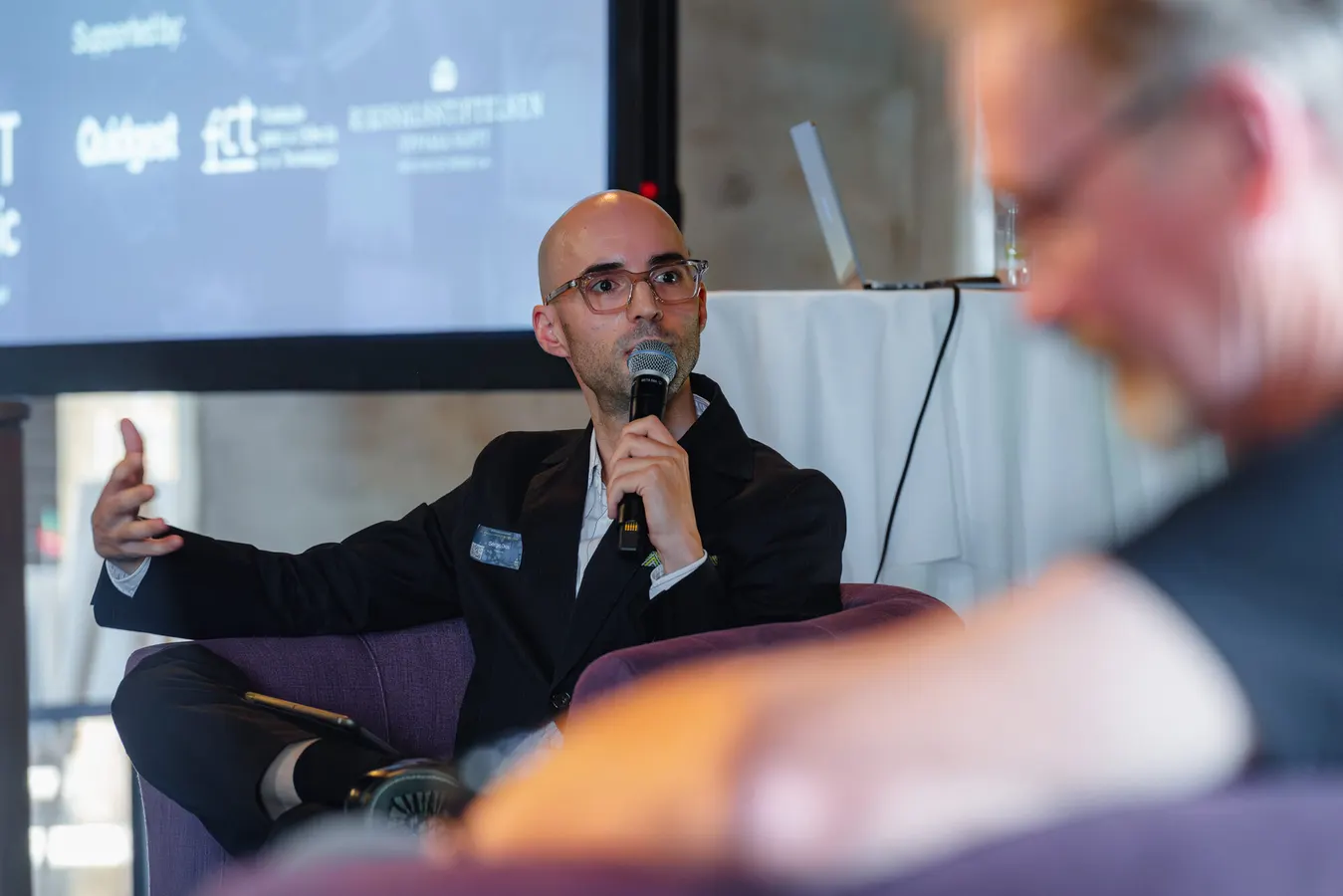 Panelist speaking into a microphone
