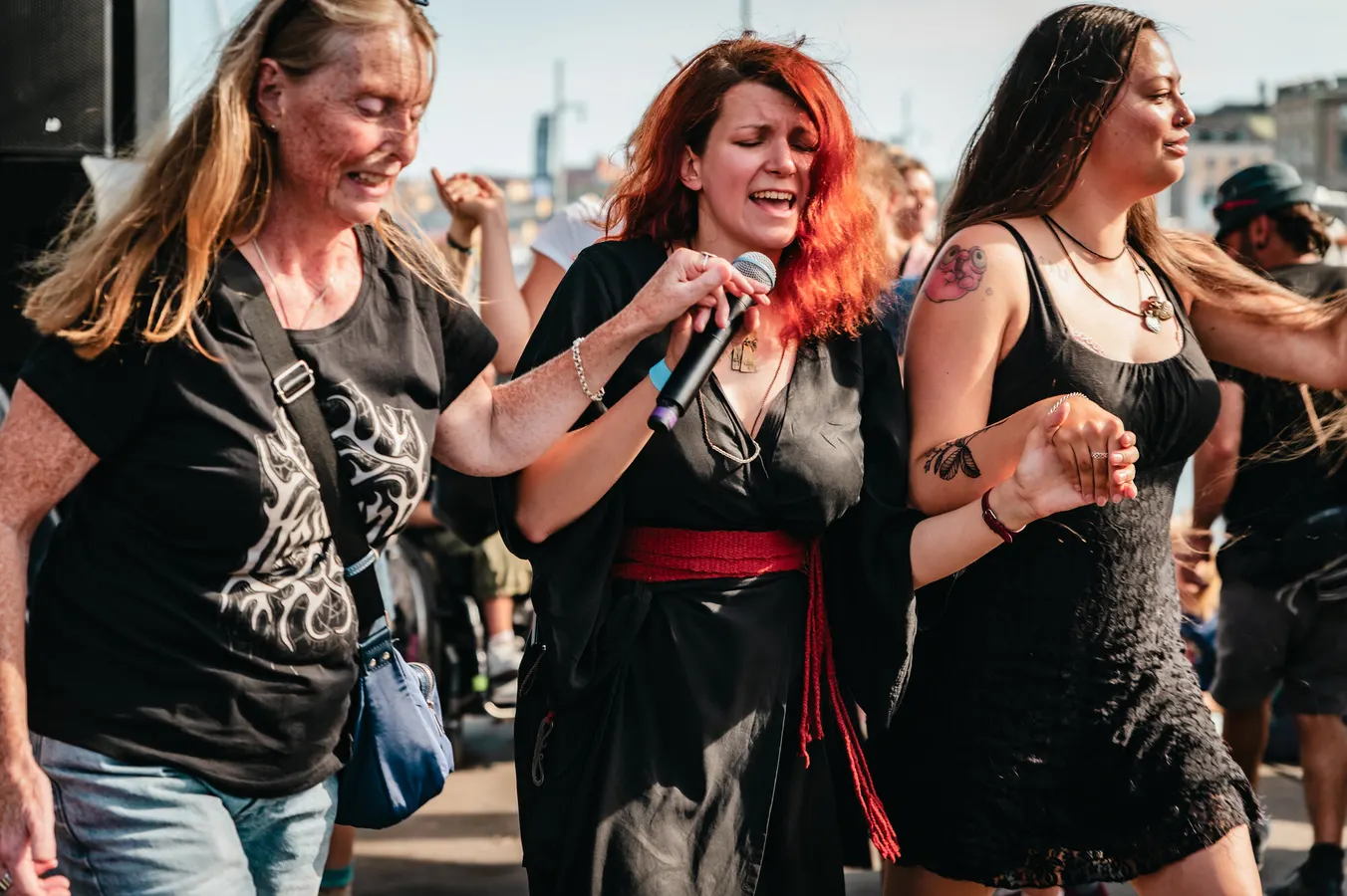 Singer performing among the crowd at an outdoor festival