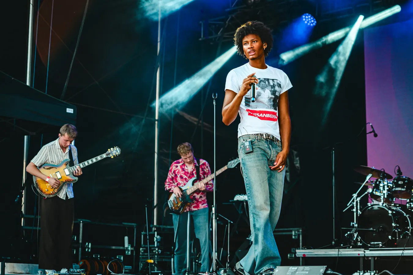 Singer on a concert stage under blue lights