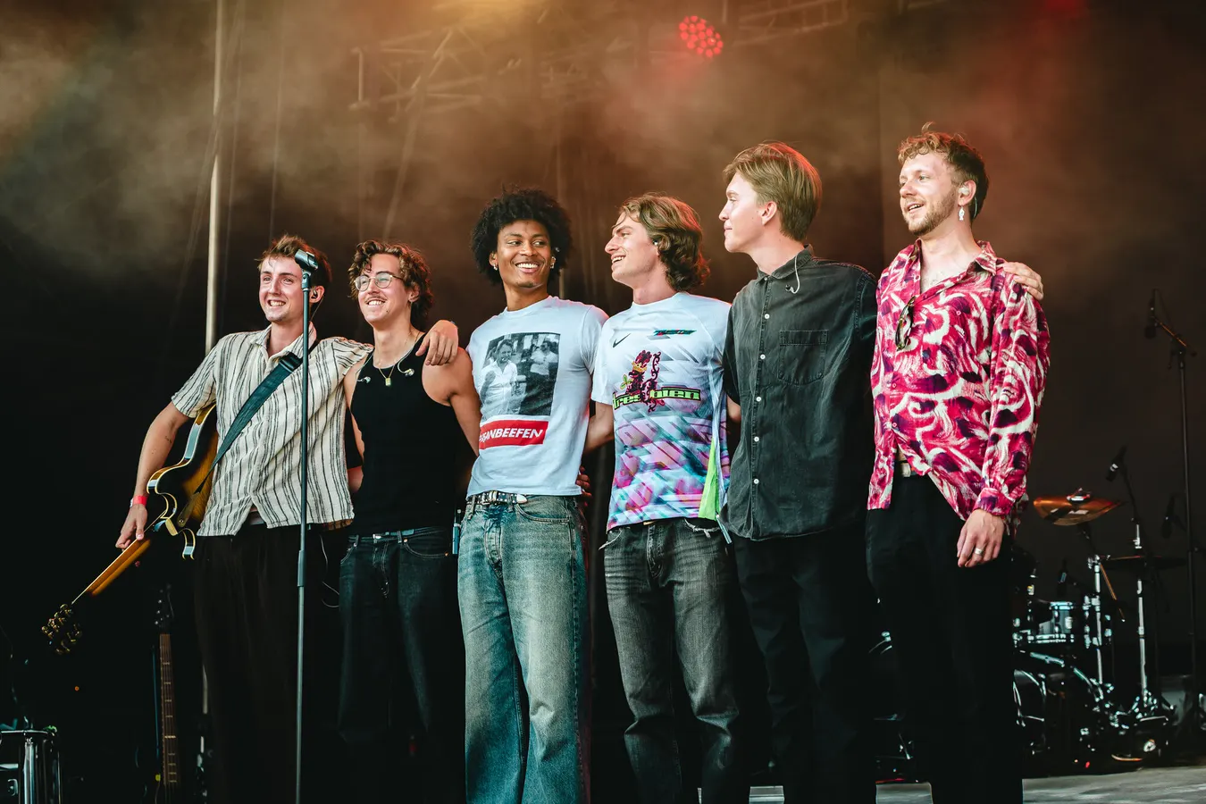Band members standing together on stage