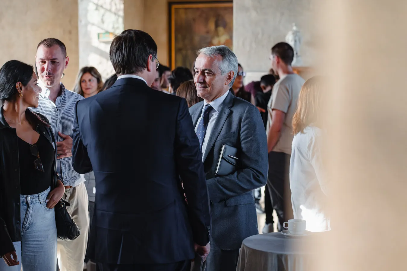 Two men in suits talking during a networking break