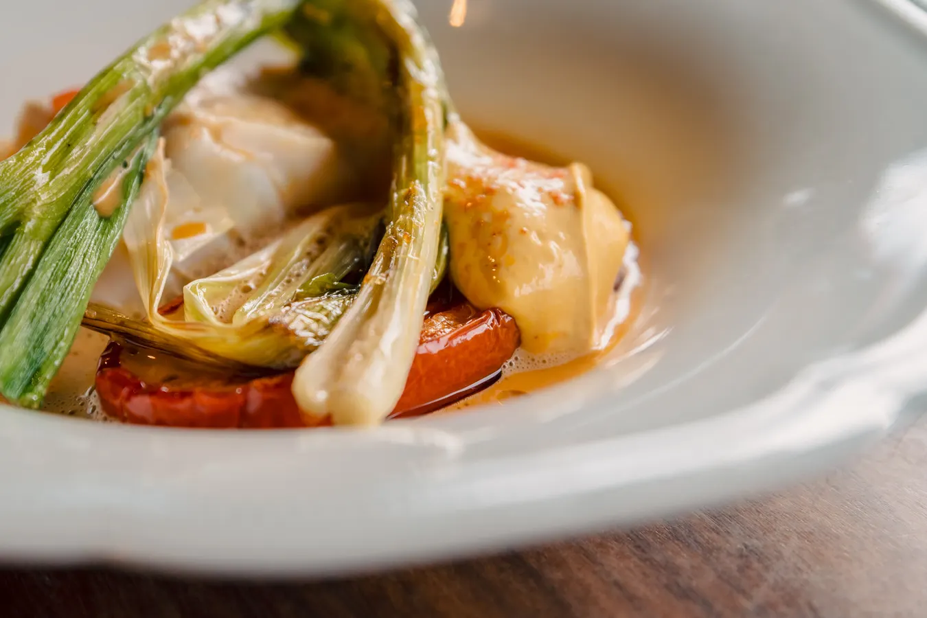 Close-up of a fish dish with grilled spring onion
