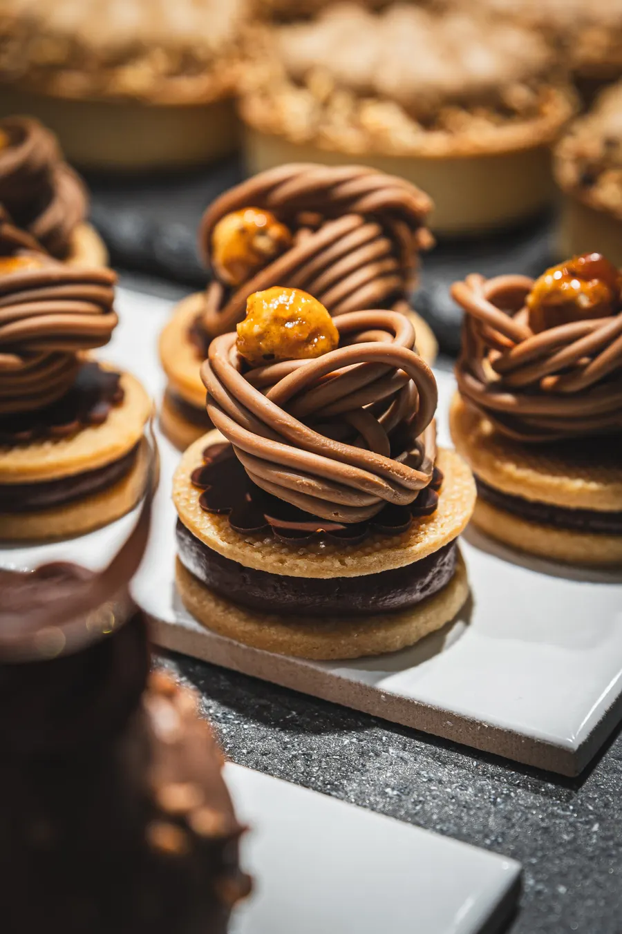 Hazelnut tarts with piped chocolate cream