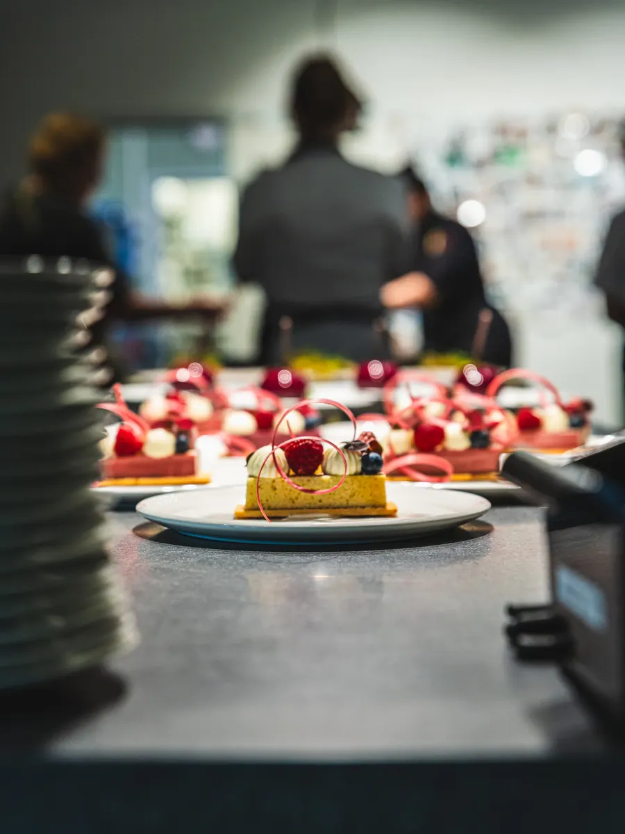 Plated desserts waiting on a kitchen pass